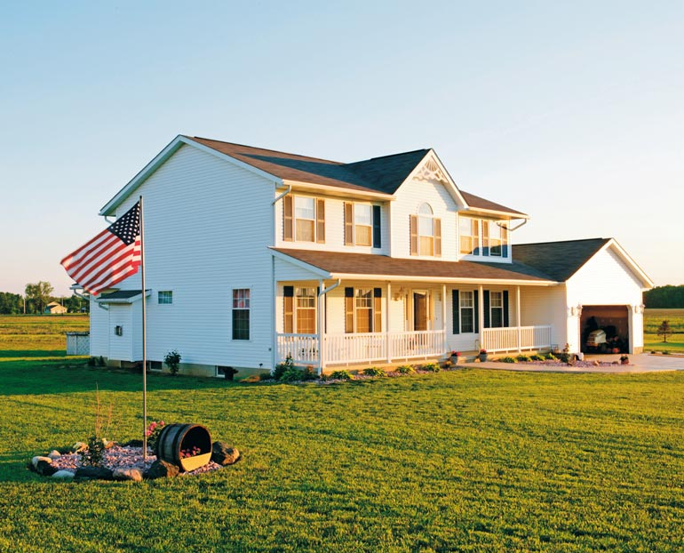 White country home with American Flag 