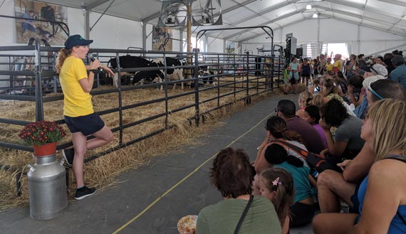 Volunteer speaking to a crowd at a community ag event