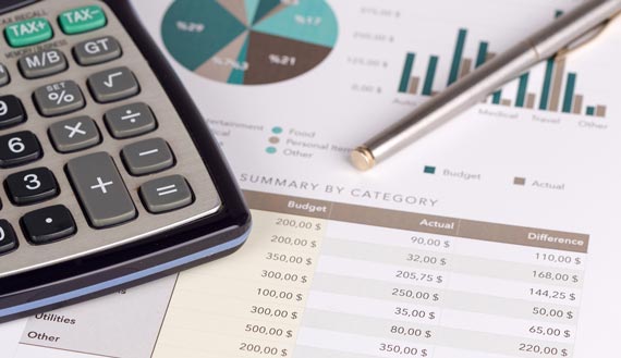 Close-up of budget sheets, graphs and a calculator 
