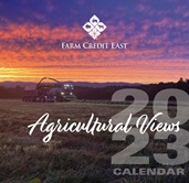2023 Agricultural Views Calendar cover. Crop field harvest with tractor and truck at sunset.