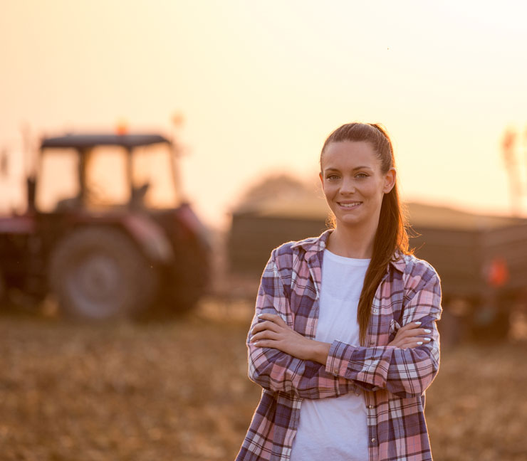 Young woman farmer in field during harvest