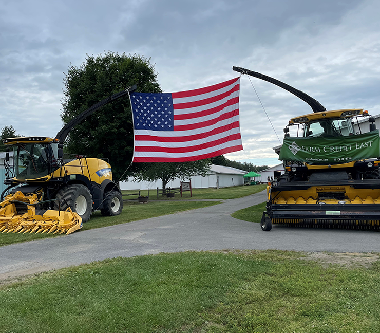 Farm equipment raising American flag