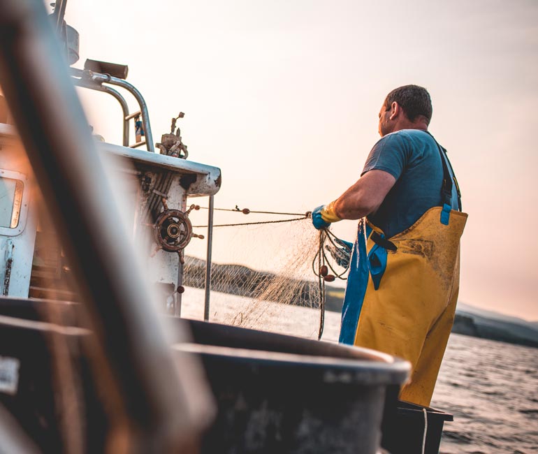 Fisherman checking nets from his fishing vessel