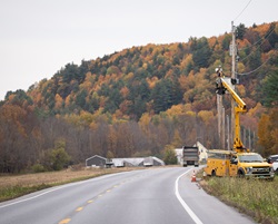 Utility work alongside rural Vermont road.