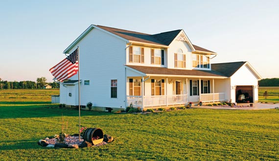 White country home with American flag 
