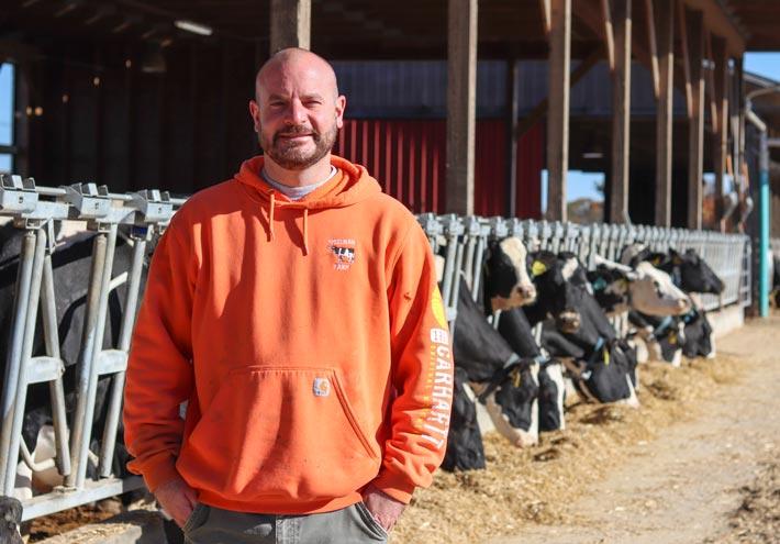 Art Spielman, of Spielman Farm, LLC in Baltic, Conn., stands in front of his herd of dairy cows 