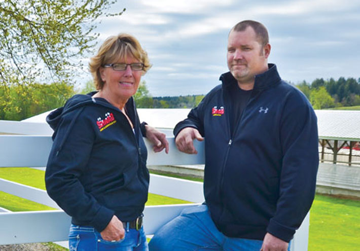 Darla and Jason Schwab of Schwab Dairy Farm pose for a photo on their dairy farm 